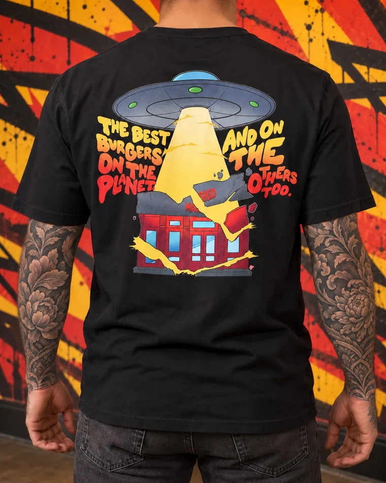 Back of the black UFO tee: a UFO beaming up a Mashed store, with “The best burgers on the planet. And on the others too.”